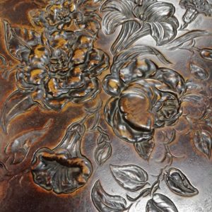 Detail of flowers carved into wood.
