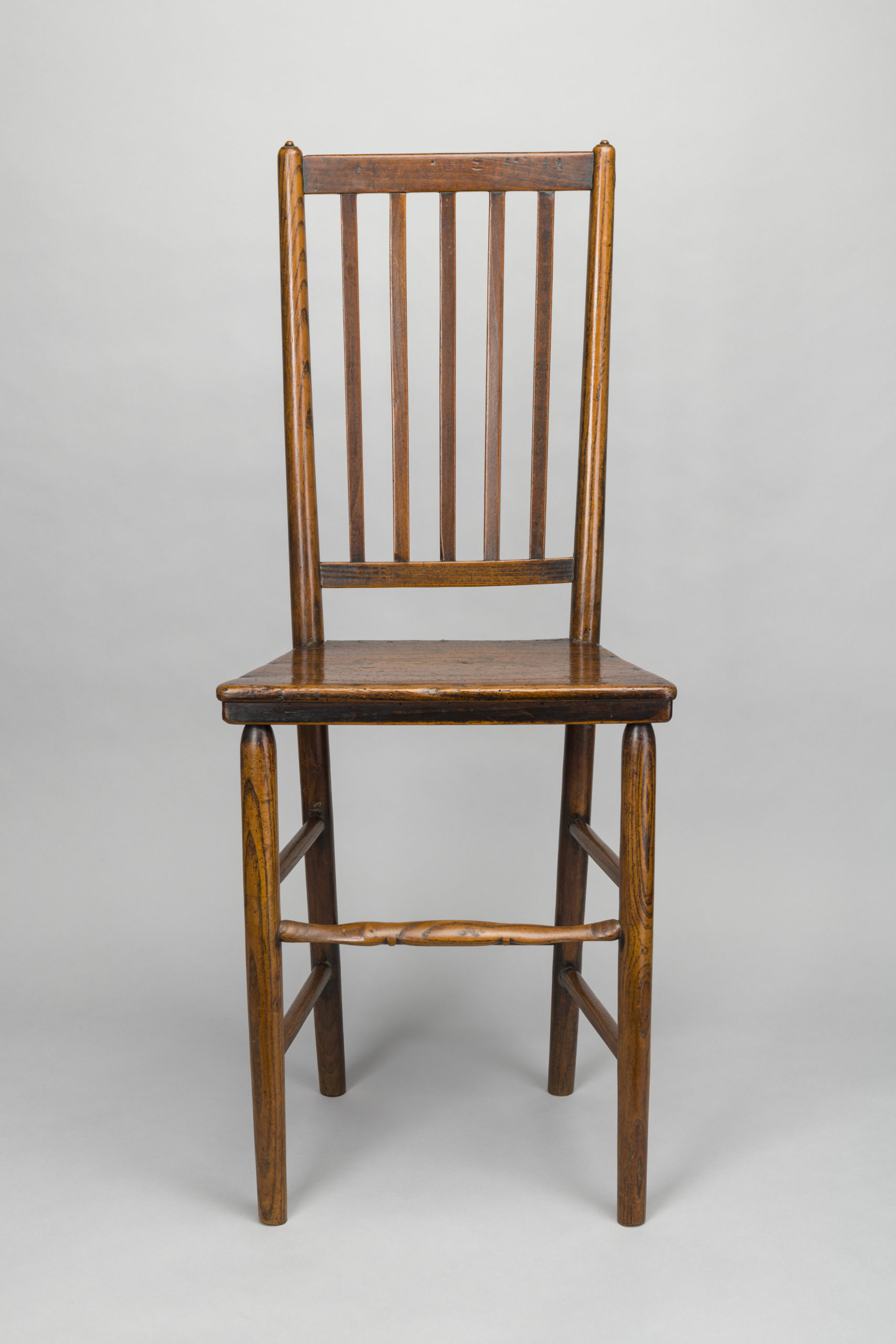 Wooden chair with spindles on the back of the chair.