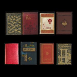 Group of eight books on a black background.