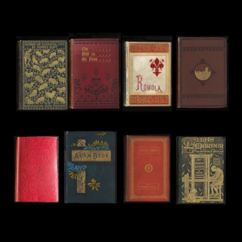 Group of eight books on a black background.