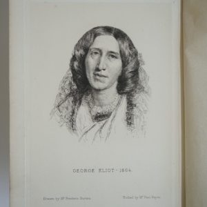 Inner page of a book showing the portrait of George Eliot. The words George Eliot - 1864. Drawn by Mr Frederic Burton. Etched by Mr Paul Rajon are typed underneath the portrait.