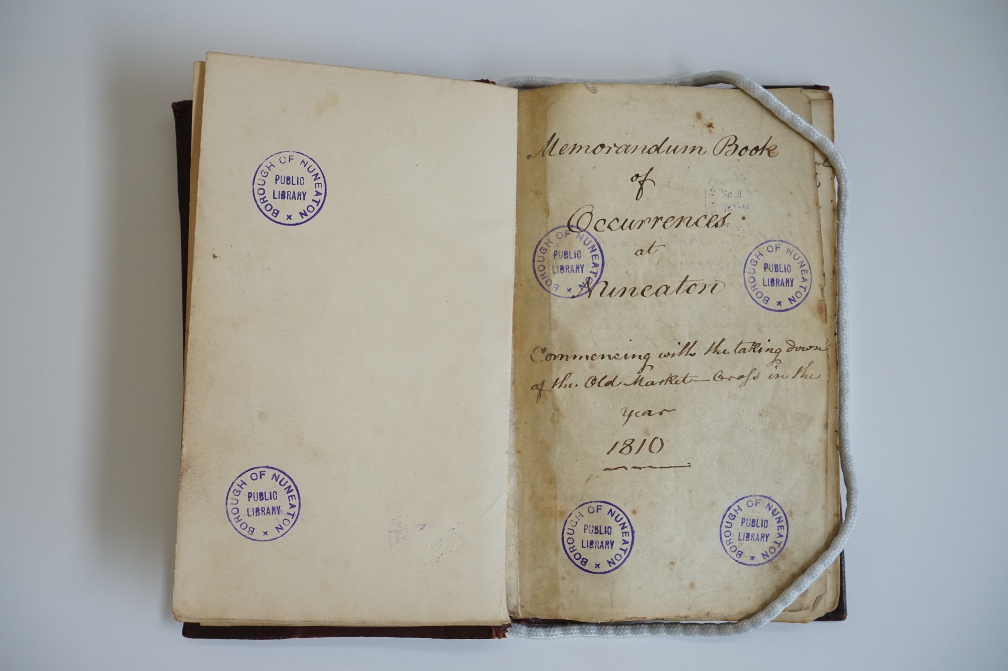 Book open at first page. Handwritten text reads: &#039;Memorandum book of occurrences at Nuneaton. 1810.